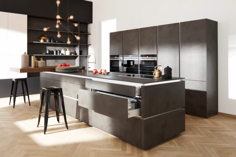 Moderne Nolte Einbauküche in griffloser Beton-Optik mit grauen Fronten, integriertem Backofen und Kochfeld.